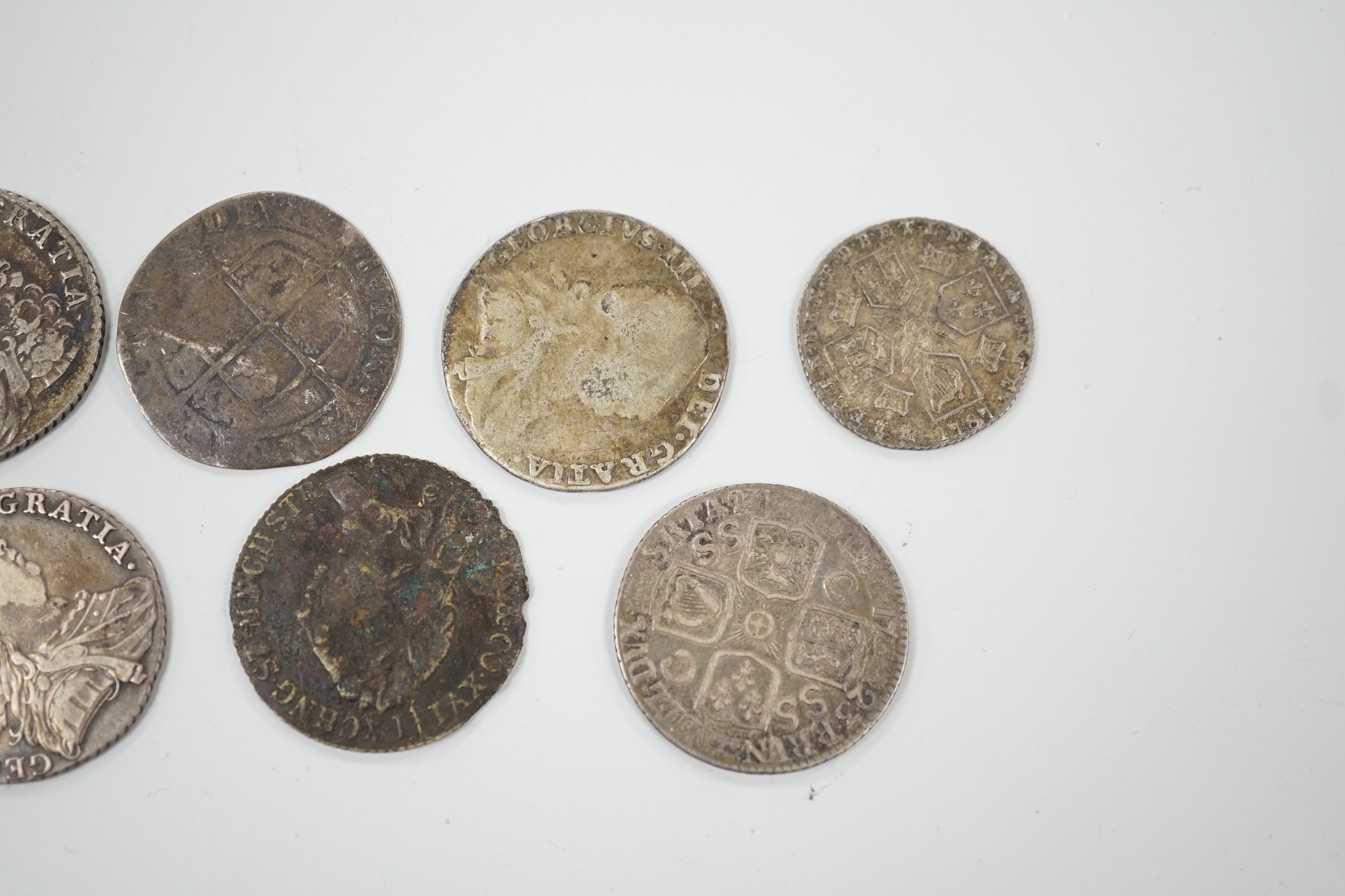Four 18th century shillings, a sixpence an Elizabeth I coin and a token